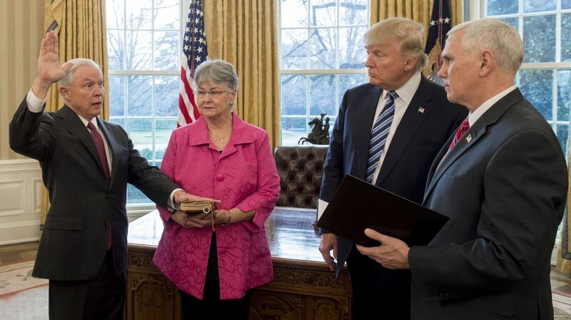 US president Donald Trump watches as Jeff Sessions, alongside his wife Mary is sworn in as attorney general by vice-president Mike Pence at the White House in Washington, DC. Photograph: Saul Loeb/AFP/Getty Images