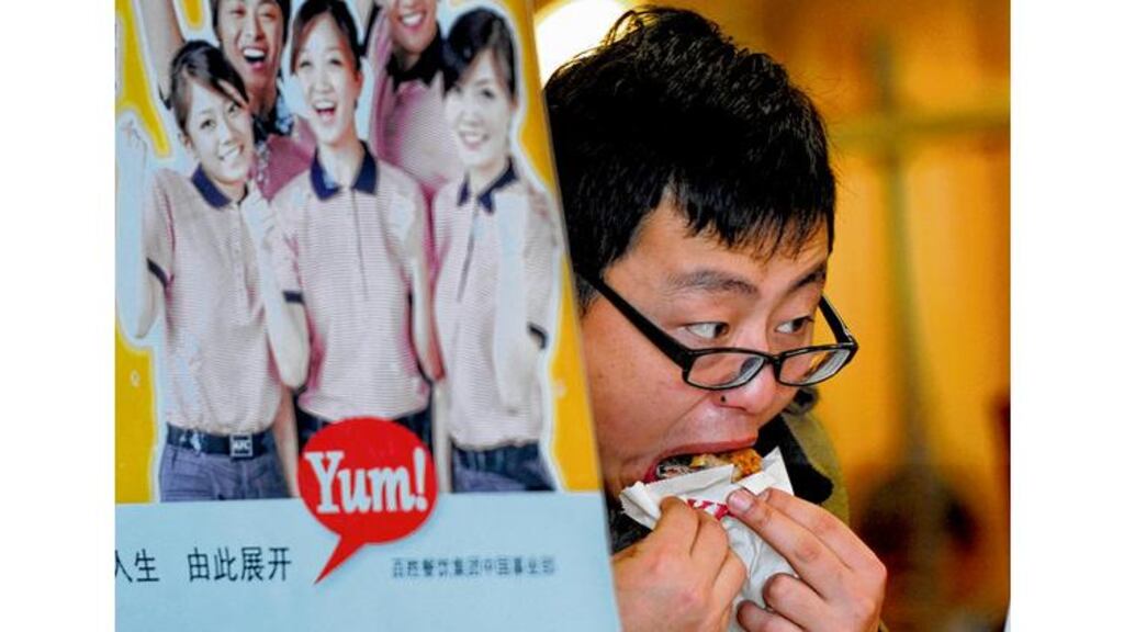 A customer eats Kentucky Fried Chicken in an outlet in Shanghai. photograph: peter parks/afp/getty