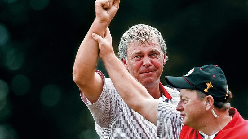 Darren Clarke of the European team has his arm raised in triumph by his captain Ian Woosnam after Clarke won his singles match on the 16th green during the 2006 Ryder Cup at the K Club. Photograph: Getty Images