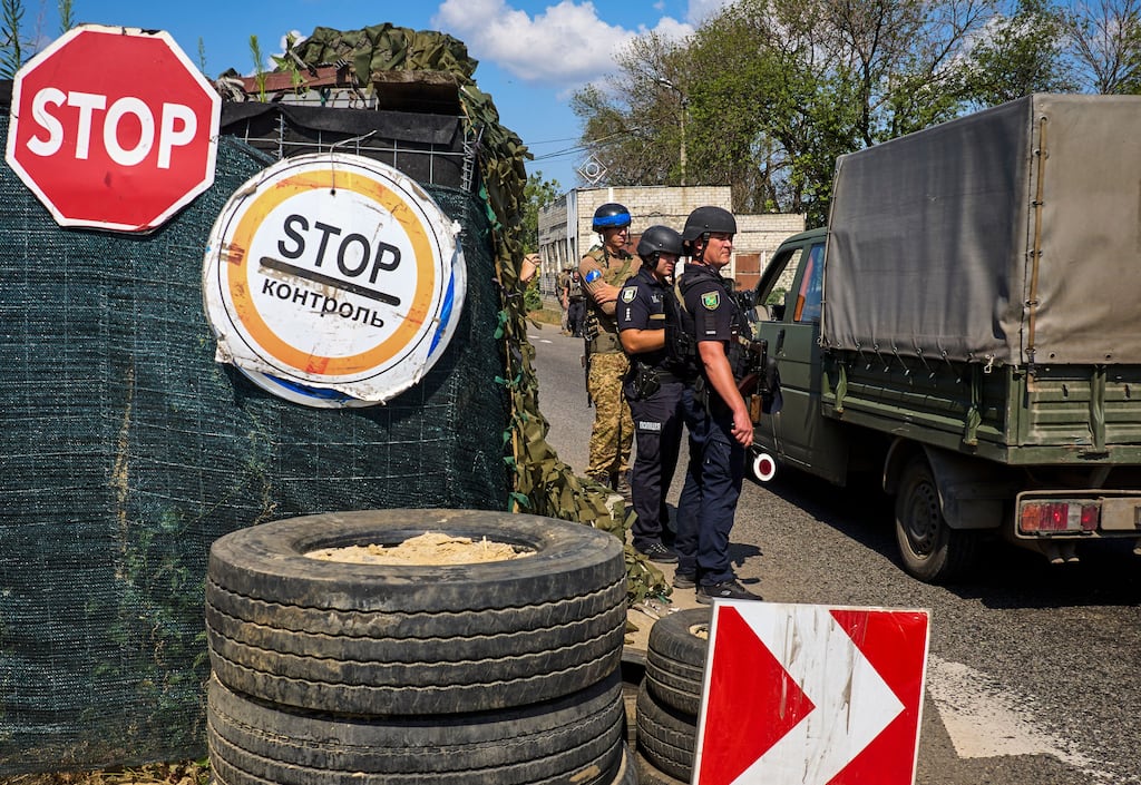 Ukrainian police and National Guard servicemen check vehicles at a checkpoint on the outskirts of Kharkiv on Friday. Photograph: Sergey Kozlov/EPA