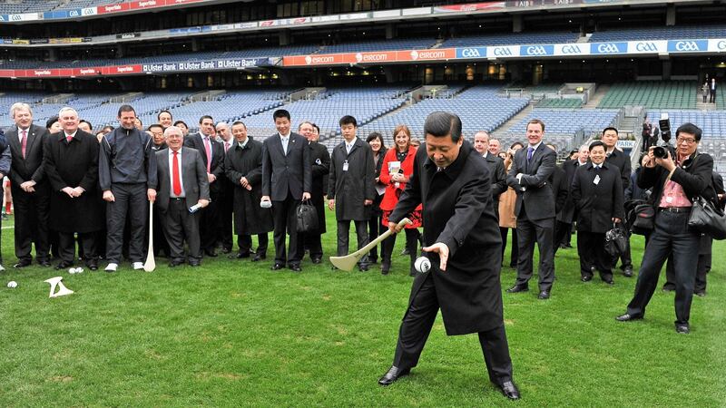 Xi Jinping tries his hand at hurling in Croke Park during his visit to Ireland . Photograph: Brendan Moran/Sportsfile