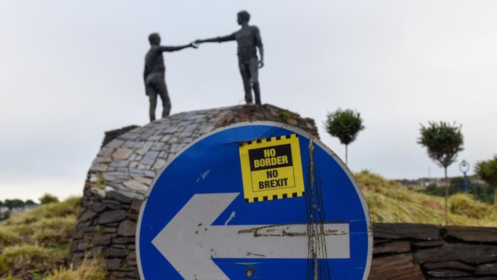 A sticker reading “No Border, No Brexit” on a road sign near the Hands Across the Divide sculpture in Derry. Photograph: Mary Turner/Bloomberg