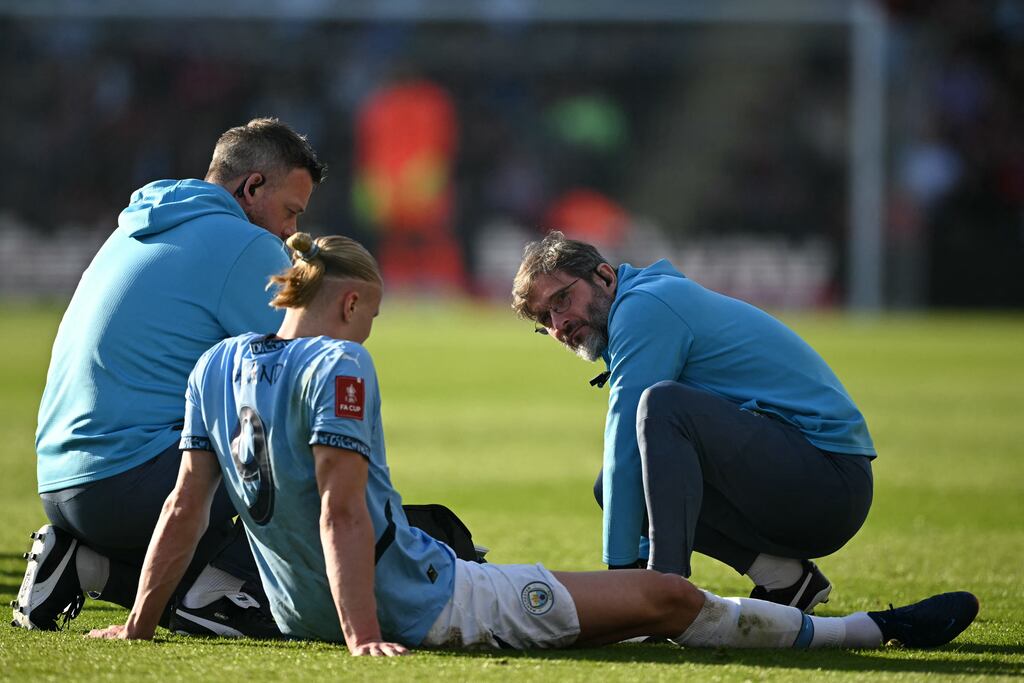 Manchester City's striker Erling Haaland receives medical attention after picking up an injury. Photograph: Justin Tallis/Getty