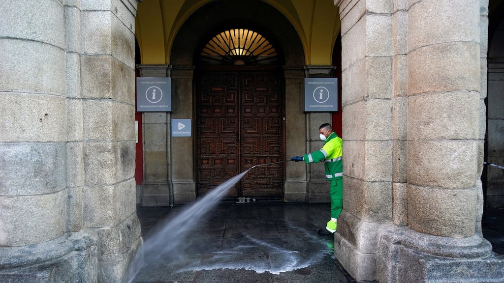 A worker of Madrid’s city hall sanitises the Plaza Mayor square during lockdown. Photograph: REUTERS/Juan Medina