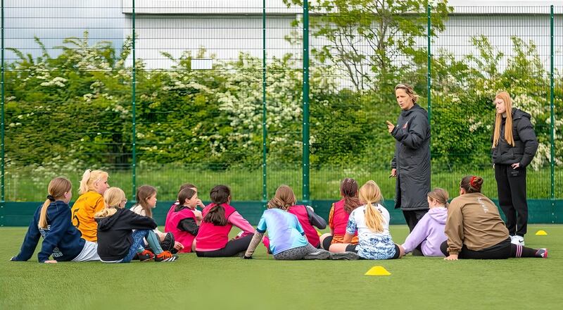 Yvonne Tracy, head of Haverhill Football Academy's girls section, talking with a group of young players at a training session earlier this month. Photograph: Haverhill Football Academy