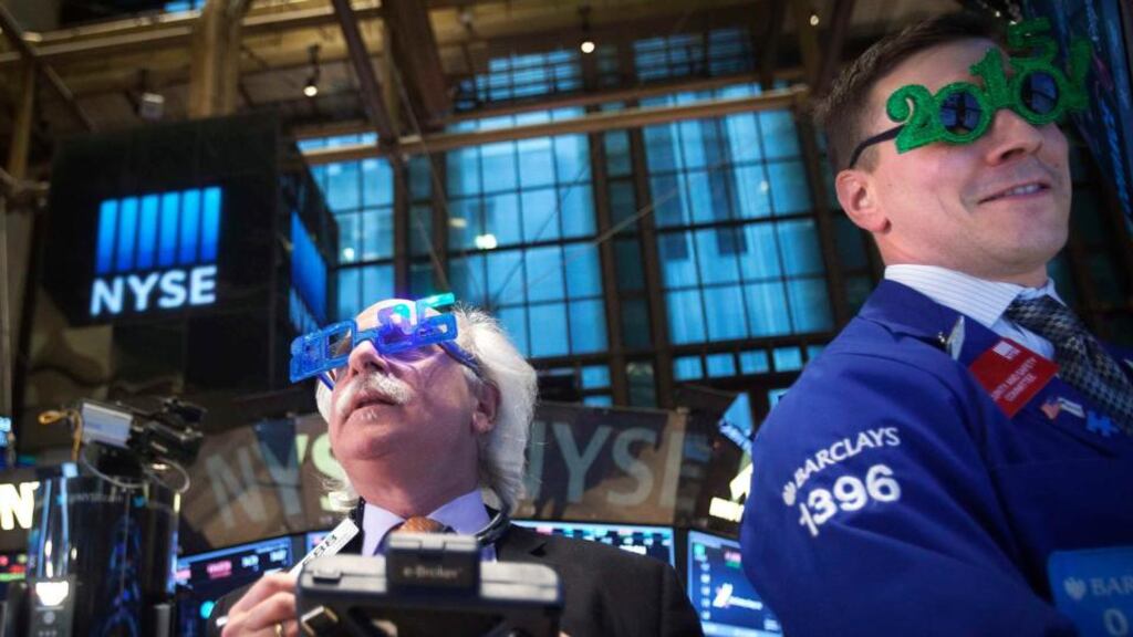 Traders on the floor of the New York Stock Exchange look forward to 2015. PHOTOGRAPH: CARLO ALLEGRI/REUTERS
