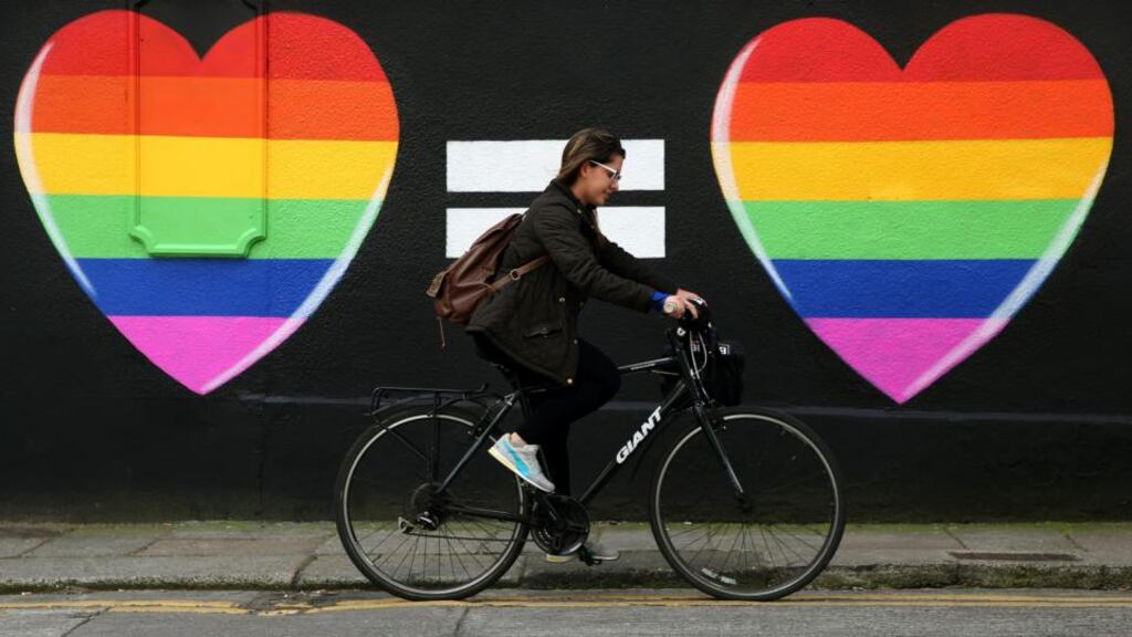 A woman cycles past a marriage equality mural in the Liberties area of Dublin. File photograph: Brian Lawless/PA Wire