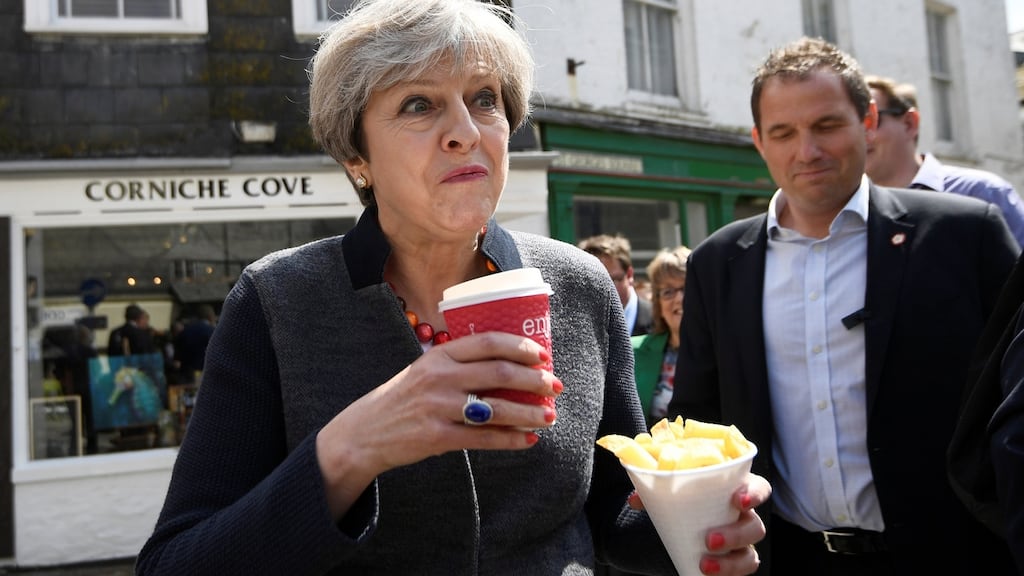 Britain’s prime minister Theresa May eating chips during a campaign stop in Mevagissey, Cornwall, on Tuesday. Photograph: Dylan Martinez/WPA Pool/Getty Images