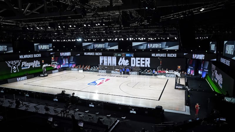 Officials stand beside an empty court after the scheduled start of game five of the NBA playoffs between the Milwaukee Bucks and the Orlando Magic was boycotted by the Bucks. Photograph: Ashley Landis/Getty Images