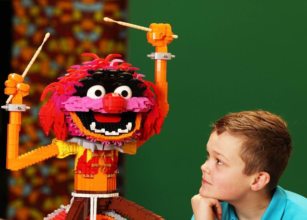 Finn Ryan, with a Lego sculpture of Animal from the Muppets sculpture) gets a sneak peak of Bricktionary: The Interactive Lego Brick Exhibition ahead of the European debut opening in Dublin on Sunday. Photograph: Leon Farrell/Photocall Ireland