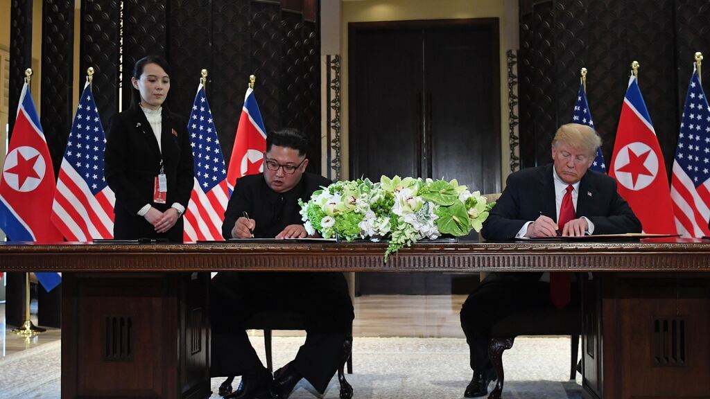 US president Donald Trump and North Korea’s leader Kim Jong-un signing documents as Mr Kim’s sister Kim Yo-jong looks on during their historic 2018 summit. Photograph: Saul Loeb/AFP via Getty Images