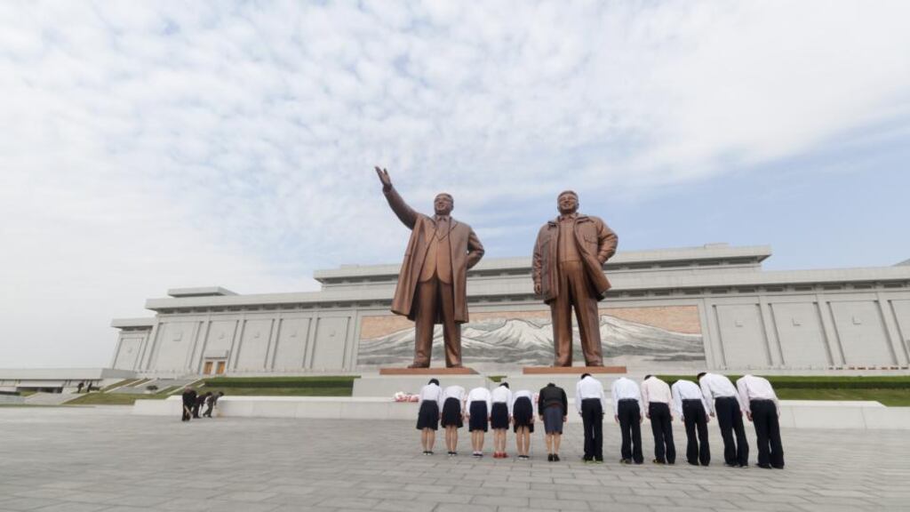 North Korean workers bow before statues of the President Kim Il Sung and the General Secretary Kim Jung Il at the Mansudae Grand Monument in Pyongyang, North Korea