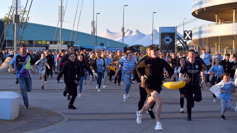 Manchester City fans race celebrate their title win at the Etihad. Photograph: Anthony Devlin/PA