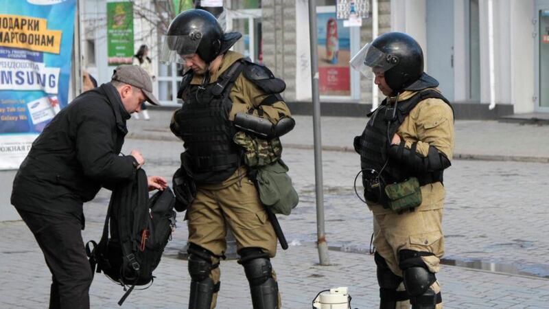 Members of a Crimean self-defence unit spot check a man’s bag on a street in Simferopol today. Photograph: Stringer /Reuters
