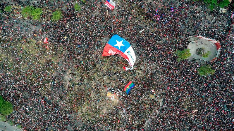 As crowds of colourful demonstrators stretched along Santiago’s thoroughfares as far as the eye could see, the noise of pots and pans being clanged with spoons, a clamour that has become the soundtrack for the popular uprising, was ear-splitting. Photograph: Pedro Ugarte/AFP/Getty