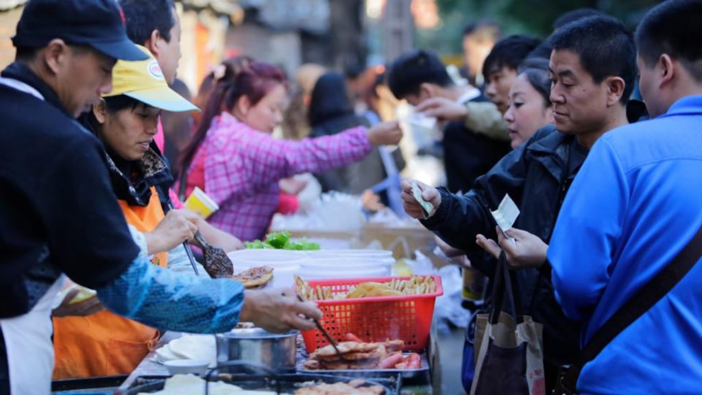 People buy their breakfast at a roadside snack booth in Beijing:  China’s consumer inflation slowed more than expected in September to a near five-year low, adding to concerns that global growth is cooling fast unless governments take bolder measures to shore up their economies. Photograph: Jason Lee/Reuters