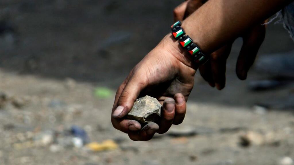 A stone held by a Palestinian protester: Israeli prime minister Binyamin Netanyahu has called an emergency ministerial meeting to consider tougher penalties for stone throwing. Photograph: Alaa Badarneh/EPA