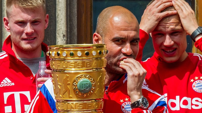Head coch Pep Guardiola holds the trophy after Bayern Munich’s German cup win over Borussia Dortmund ikn Berlin in 2014. Photograph: Marc Mueller/AP