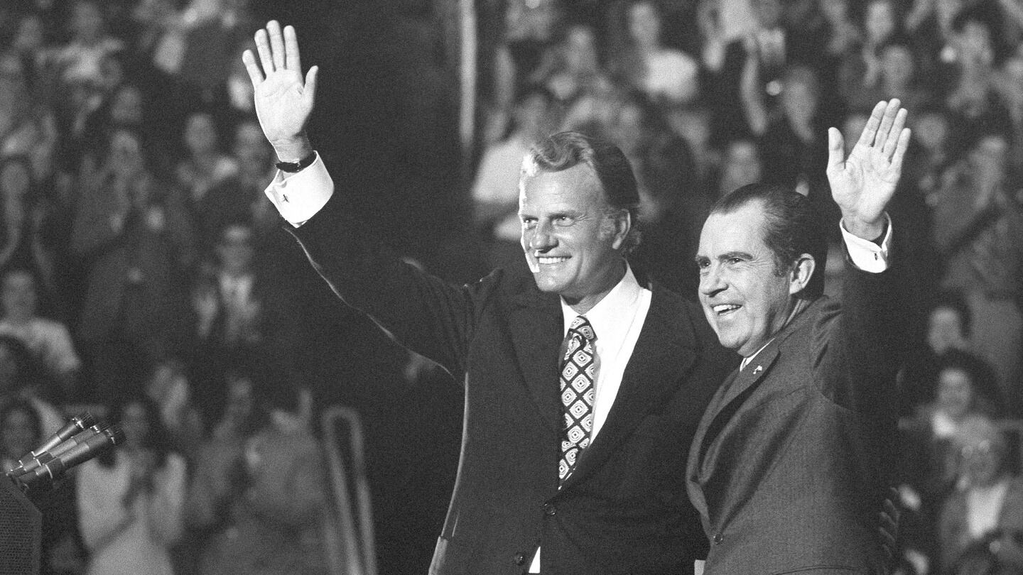 Billy Graham and President Richard Nixon wave to a crowd of 12,500 at ceremonies honouring Graham at Charlotte, North Carolina, in October 1971. Photograph: AP Photo