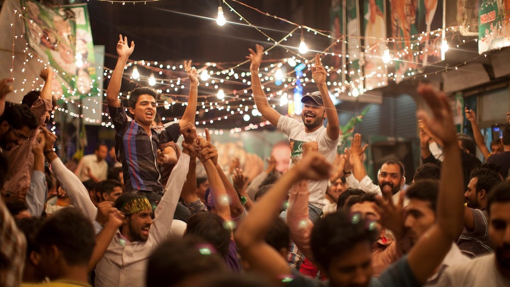 People celebrate in the streets of Lahore, Pakistan, after Nawaz Sharif, a former prime minister, declared that his party, the Pakistan Muslim League-Nawaz, would emerge as winner of the election. Photograph: Tyler Hicks/The New York Times.