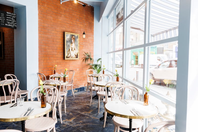 There are a handful of tables outside under a blue and white striped awning with heaters, and even though it’s a very busy junction, it’s an interesting place to loiter over a glass of wine