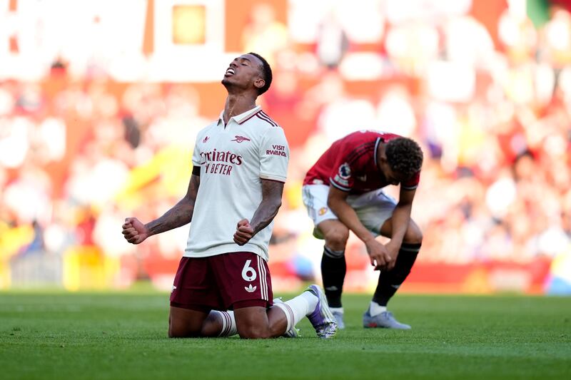 Manchester United's Matheus Cunha appears dejected as Arsenal's Gabriel celebrates after the final whistle. Photograph: Nick Potts/PA Wire
