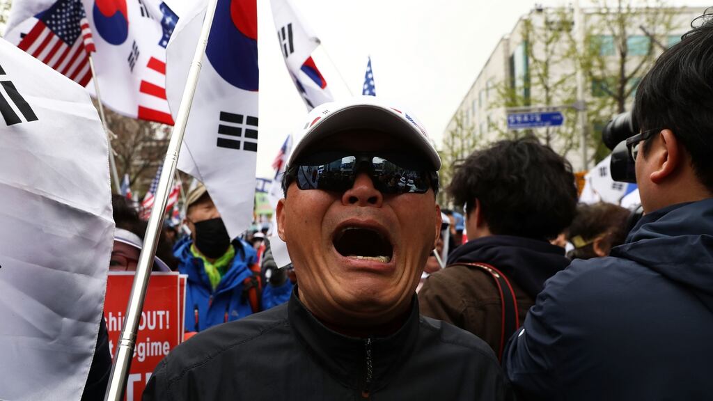 Supporters of former president Park Geun-hye react after a court sentenced her to 24 years in prison and a fine of 18 billion won. Photograph: Chung Sung-Jun/Getty Images