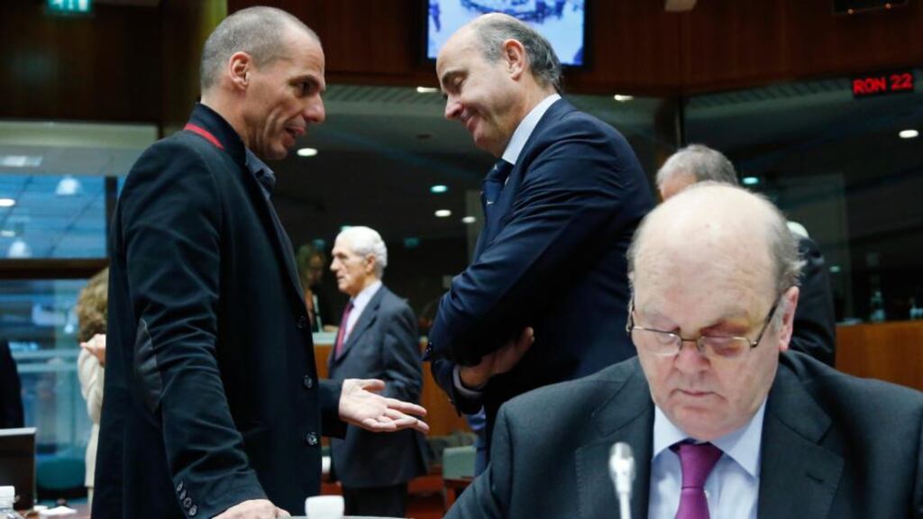 Greek finance minister Yanis Varoufakis (left) talks to Spanish economy minister Luis de Guindos next to Michael Noonan during a European Union finance ministers meeting in Brussels February 17th, 2015. Photograph: Reuters/Francois Lenoir