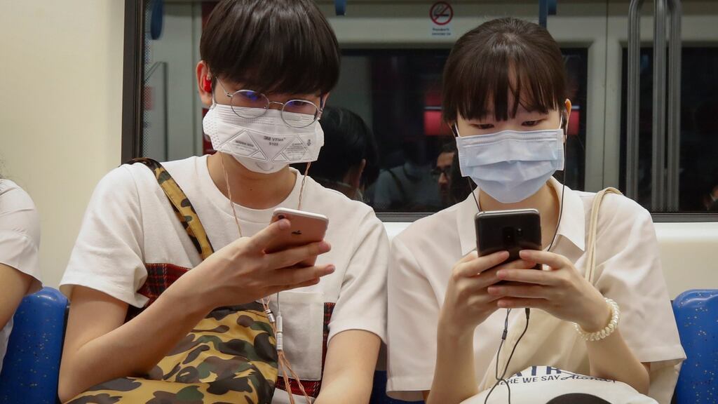 Commuters wear protective face masks on the Bangkok underground on Wednesday. Coronavirus was hard to escape on the markets. Photograph: EPA