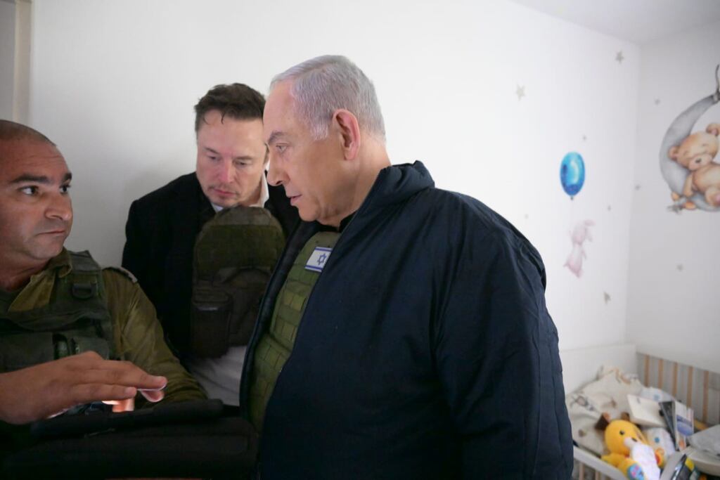 Israel's prime minister Binyamin Netanyahu takes Elon Musk (centre) on a tour of Kibbutz Kfar Aza. Photograph: Amos Ben-Gershom (GPO) Handout via Getty Images