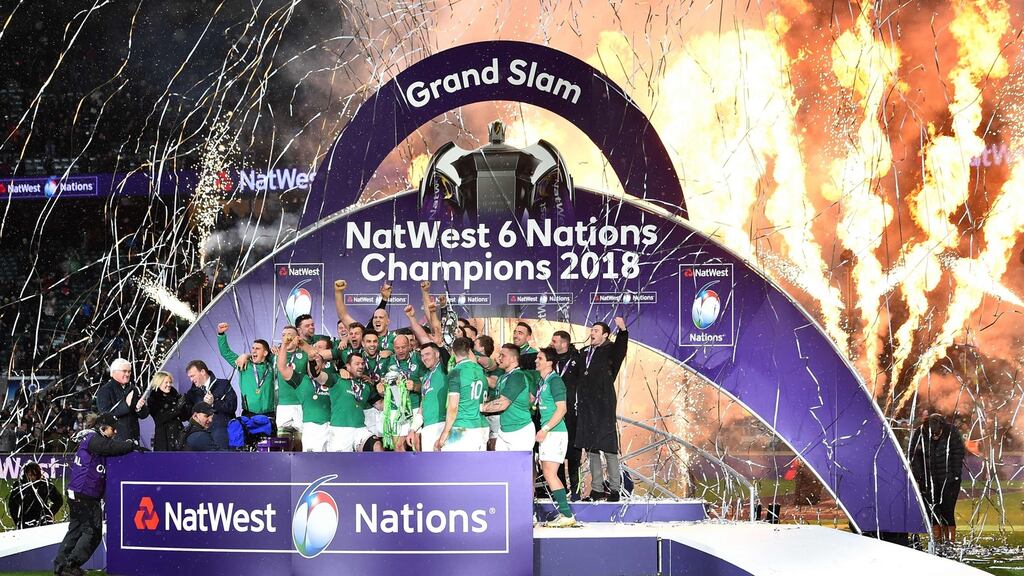 Ireland’s hooker Rory Best holds the Six Nations trophy and outhalf Jonathan Sexton lifts the Triple Crown in Twickenham. Photograph: Getty Images