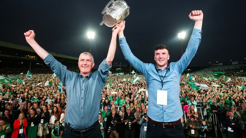 Job done: John Kiely and Declan Hannon lift the Liam MacCarthy cup before the jubilant home fans at the Gaelic Grounds.  Photograph: Tommy Dickson/Inpho