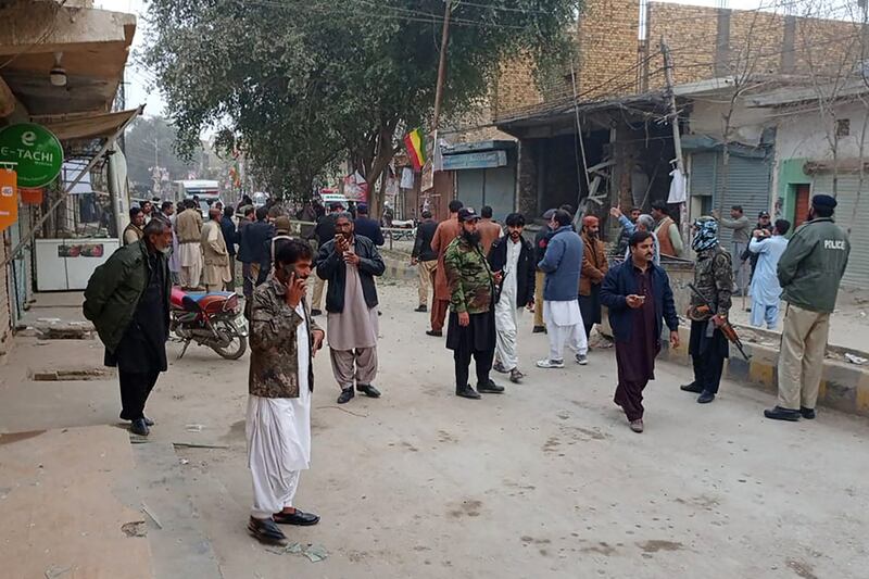 Security personnel and people gather near the site of a bomb explosion at Sibi, in Balochistan province, Pakistan, on Tuesday. Photograph: AFP via Getty Images