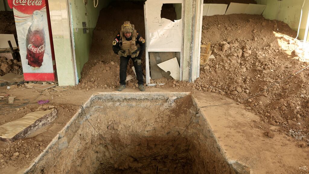 An Iraqi special forces soldier looks inside the entrance of a tunnel used by Islamic State militants in a restaurant in Bazwaya, east of Mosul, on Thursday. Photograph: Zohra Bensemra/Reuters