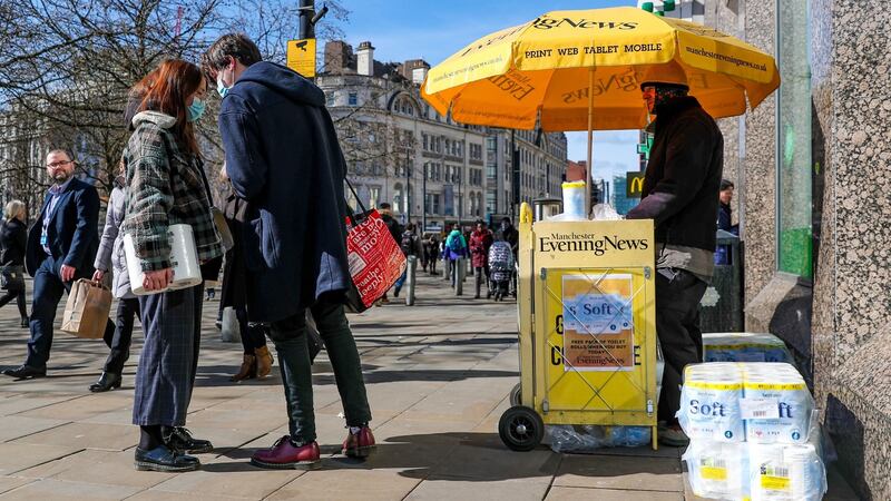 A newspaper vendor in Manchester city centre on March 16th giving away free toilet rolls with every paper bought. Photograph: Peter Byrne/PA
