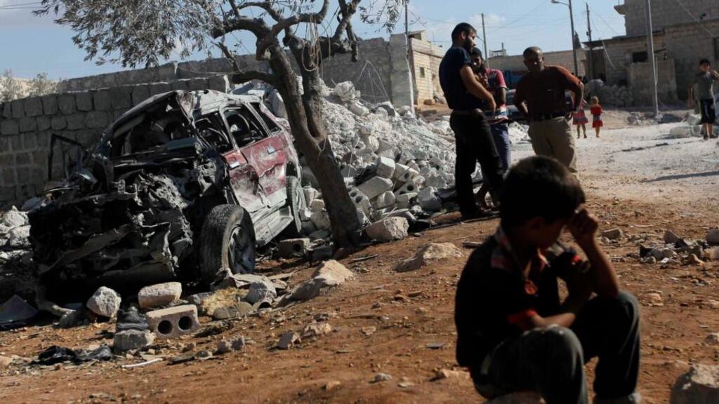 Residents inspect a site damaged in what activists say was a US strike in Kfredrian, Idlib province in Syria yesterday. Photograph: Abdalghne Karoof /Reuters