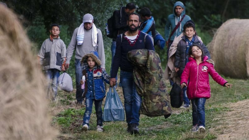 Migrants at the border between Hungary and Serbia. Hungary says it is building a four-metre high fence to keep out migrants. Photograph: Csaba Segesvari/AFP/Getty Images