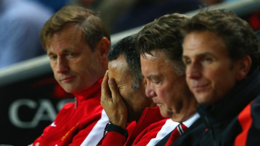 Assistant manager Ryan Giggs (second left) looks dejected with manager Louis van Gaal (second right) of Manchester United during the Capital One Cup defeat to MK Dons at Stadium mk. Photograph: Clive Mason/Getty Images