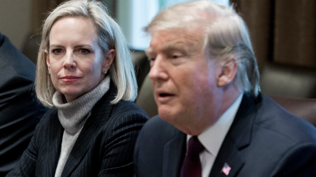 Former US secretary of Homeland Security Kirstjen Nielsen (L) listens to US president Donald Trump on January 23rd. Photograph: EPA/MICHAEL REYNOLDS