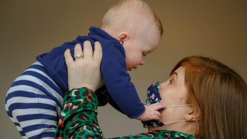 Ciara Clancy holds up her 6-month-old son Iarla in Conna, Co Cork. Photograph: Daragh Mc Sweeney/Provision