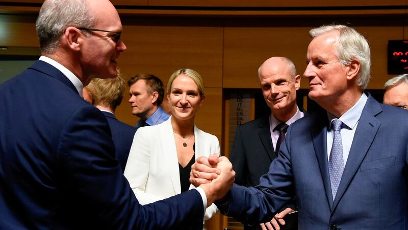 Tánaiste Simon Coveney (left) shakes hands with EU chief Brexit negotiator Michel Barnier. Photograph: John Thys/AFP via Getty Images