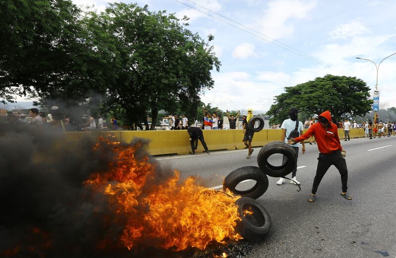 Opponents of Venezuelan president Nicolás Maduro's government burn tyres during a protest in Valencia, in the state of Carabobo, Venezuela. Photograph: Juan Carlos Hernandez/AFP via Getty Images