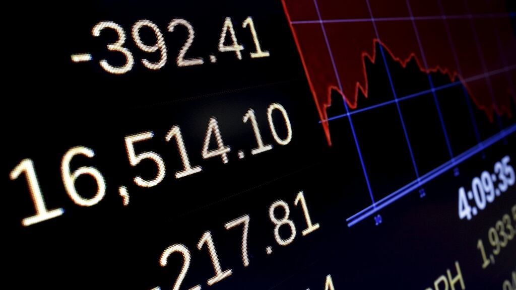 A screen displays the Dow Jones Industrial Average on the floor of the New York Stock Exchange