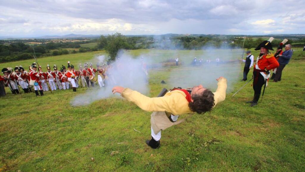 Redcoats execute a rebel prisoner by firing squad during yesterday’s re-enactment of the Battle of Vinegar Hill, which saw the crushing of the 1798 Rebellion. Photograph: Patrick Browne.