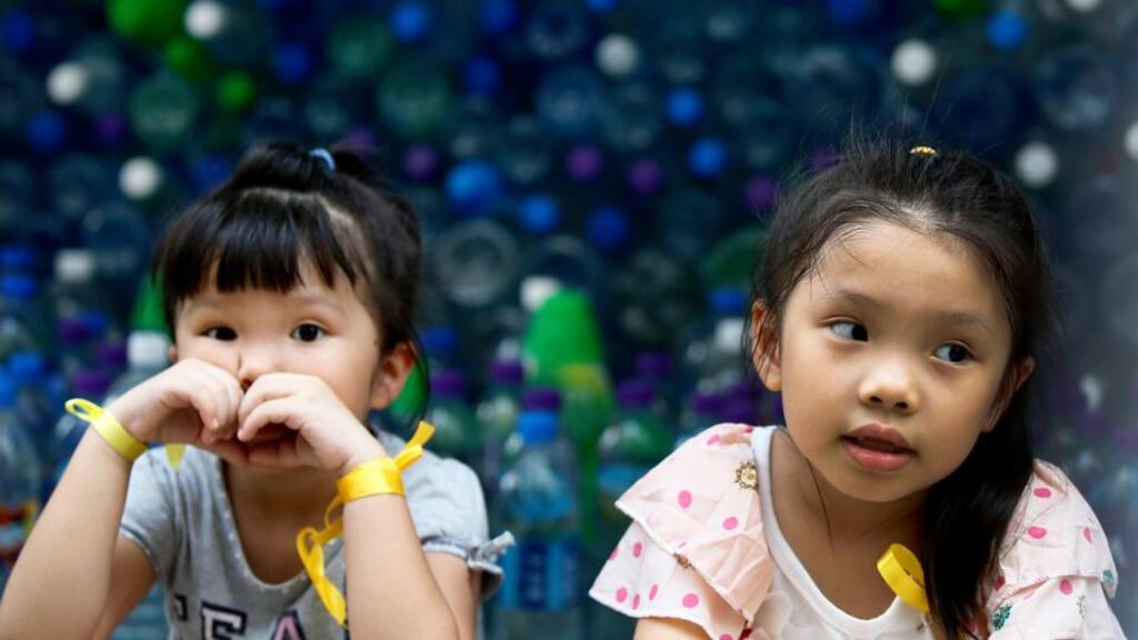 Children wearing yellow ribbons sit in front of donated bottled water on the fifth day of the mass civil disobedience campaign Occupy Hong Kong, in Causeway Bay, Hong Kong, yesterday. Photograph: EPA/Dennis M Sabangan
