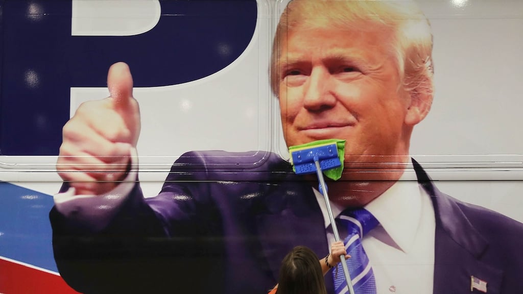 Bailey McDaniel wipes off the side of the campaign bus of Republican presidential candidate Donald Trump before his campaign rally at the South Florida Fair & Expo Center in West Palm Beach, Florida. Photograph: Joe Raedle/Getty Images