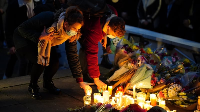Floral tributes and candles are left after a vigil outside the London Irish Centre in Camden in memory of murdered primary school teacher 23-year-old Ashling Murphy, who was found dead on Wednesday afternoon after going for a run on the banks of the Grand Canal in Tullamore, Co Offaly in the Republic of Ireland. Photograph: Dominic Lipinski/PA Wire
