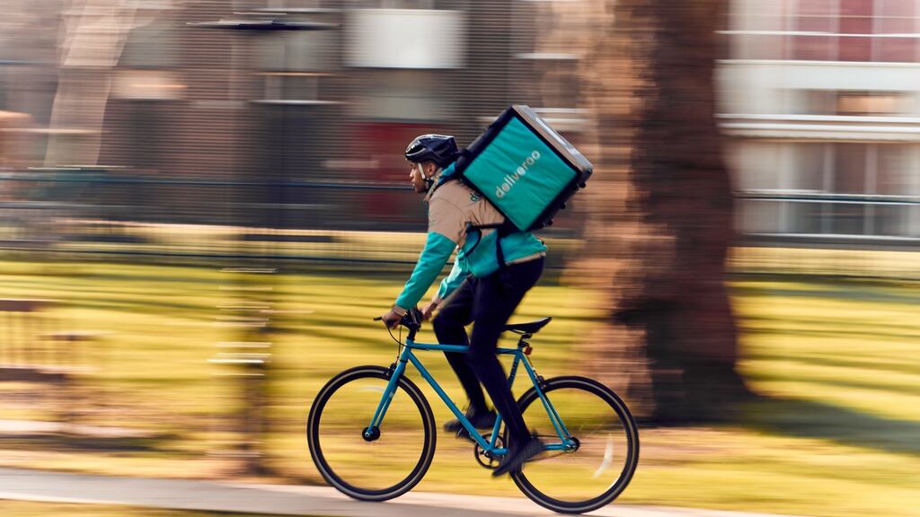 A Deliveroo worker goes about his business. As the law tries to catch up with the technology, a couple of companies dig their heels in – Air BnB, Uber, Lyft, Deliveroo, TaskRabbit, Deliveroo. Photograph: Mikael Buck/Deliveroo