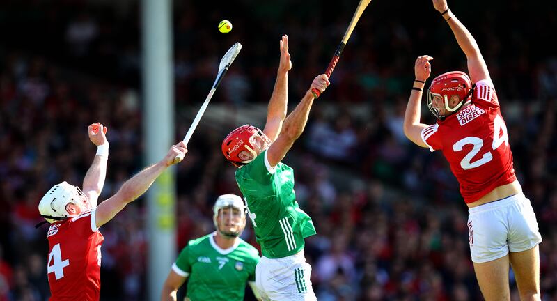 Limerick’s Barry Nash with Patrick Horgan and Brian Hayes of Cork. Photograph: Ryan Byrne/Inpho