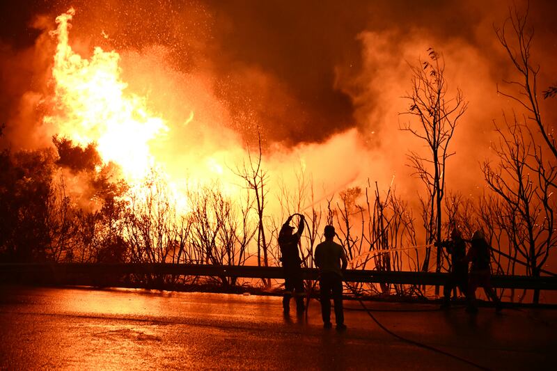 Firefighters tackle a blaze near the city of Patras, western Greece. Photograph: Aris Messinis/AFP/Getty